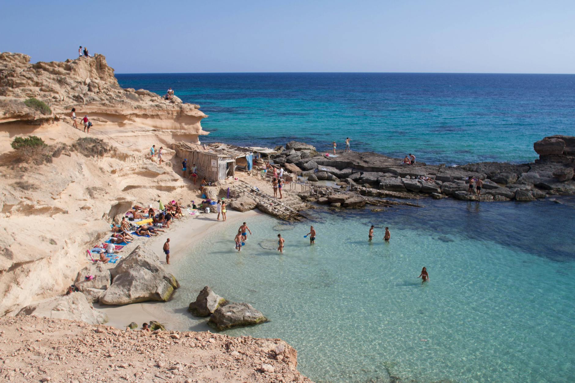 Families enjoying a sheltered rocky cove beach in the Balearic Islands