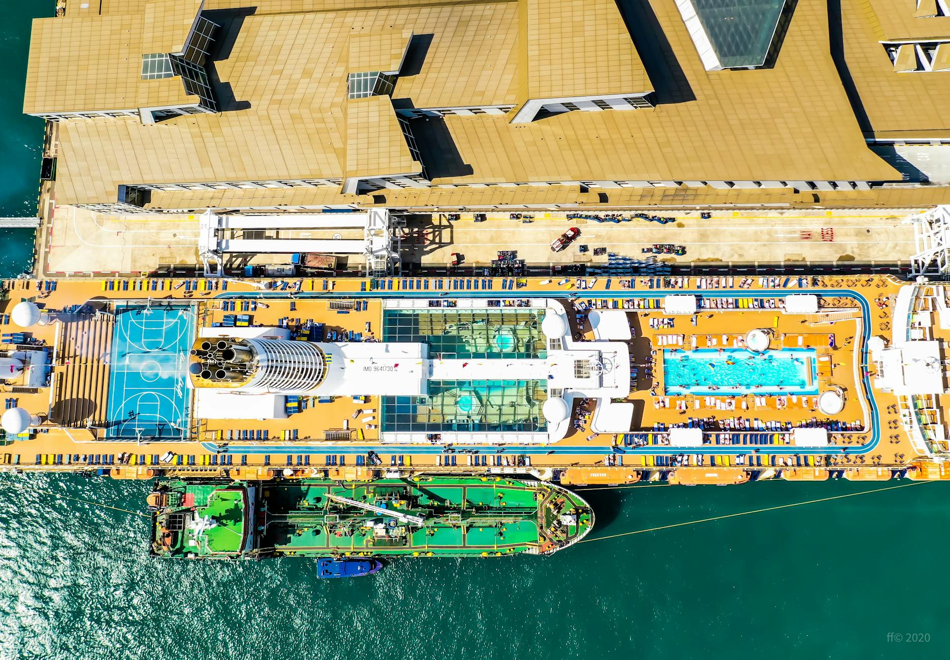 Aerial view of cruise ship pool deck with colorful slides and lounging area