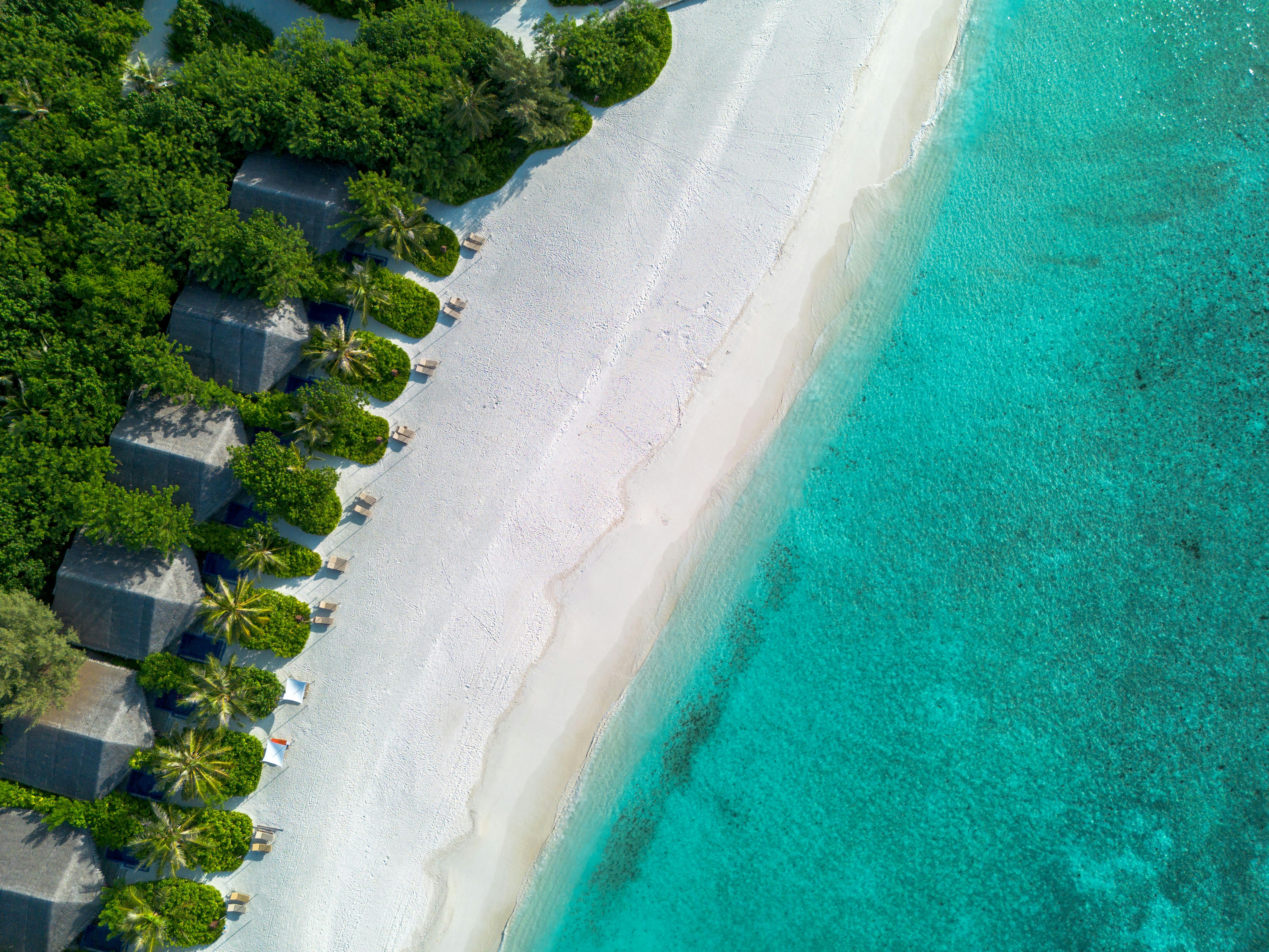 Caribbean tropical beach aerial with white sand and turquoise water representing the Beaches Turks and Caicos reef-luxury family side