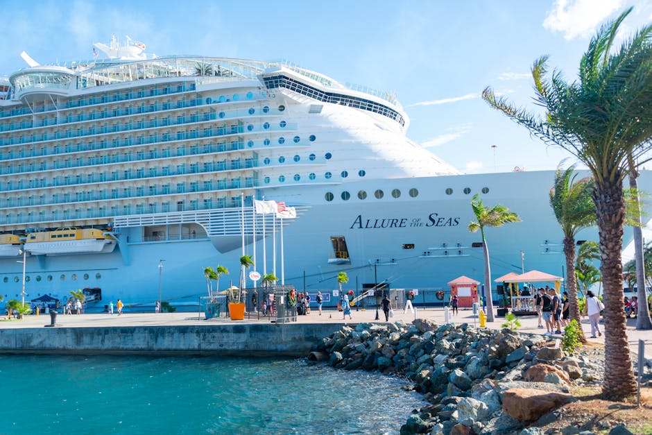 Large cruise ship docked at a tropical Caribbean port with blue water