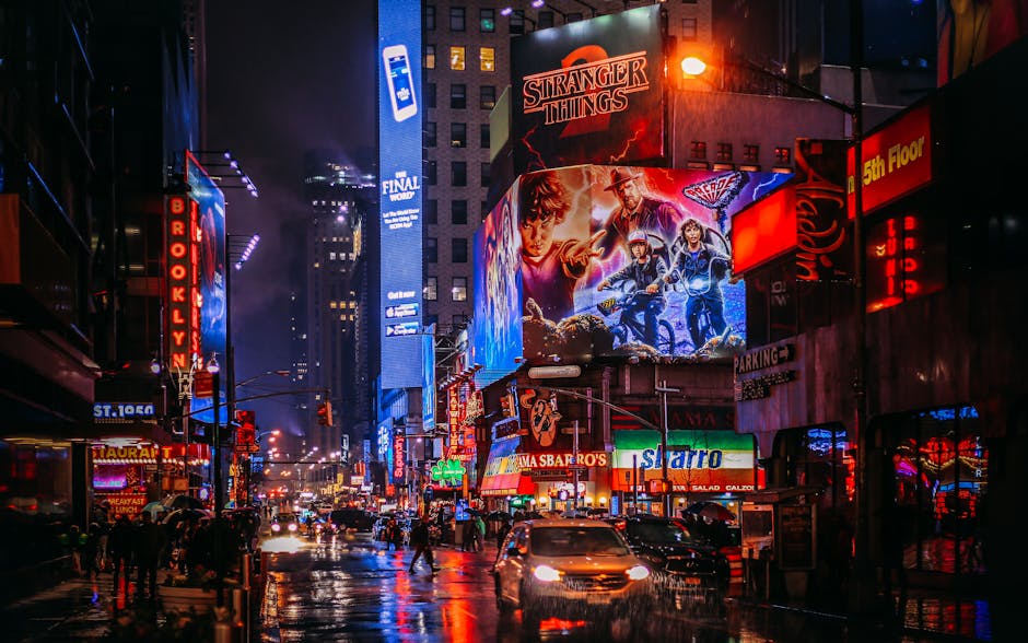 Bustling Times Square at night with bright lights and crowds