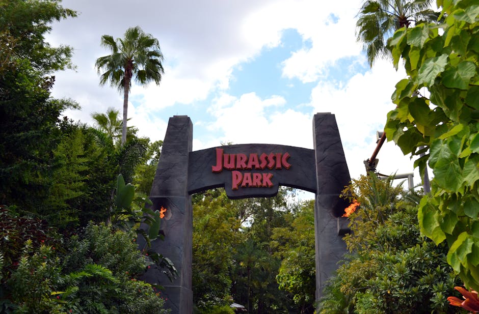 Jurassic Park entrance at Universal Studios Orlando surrounded by lush landscaping