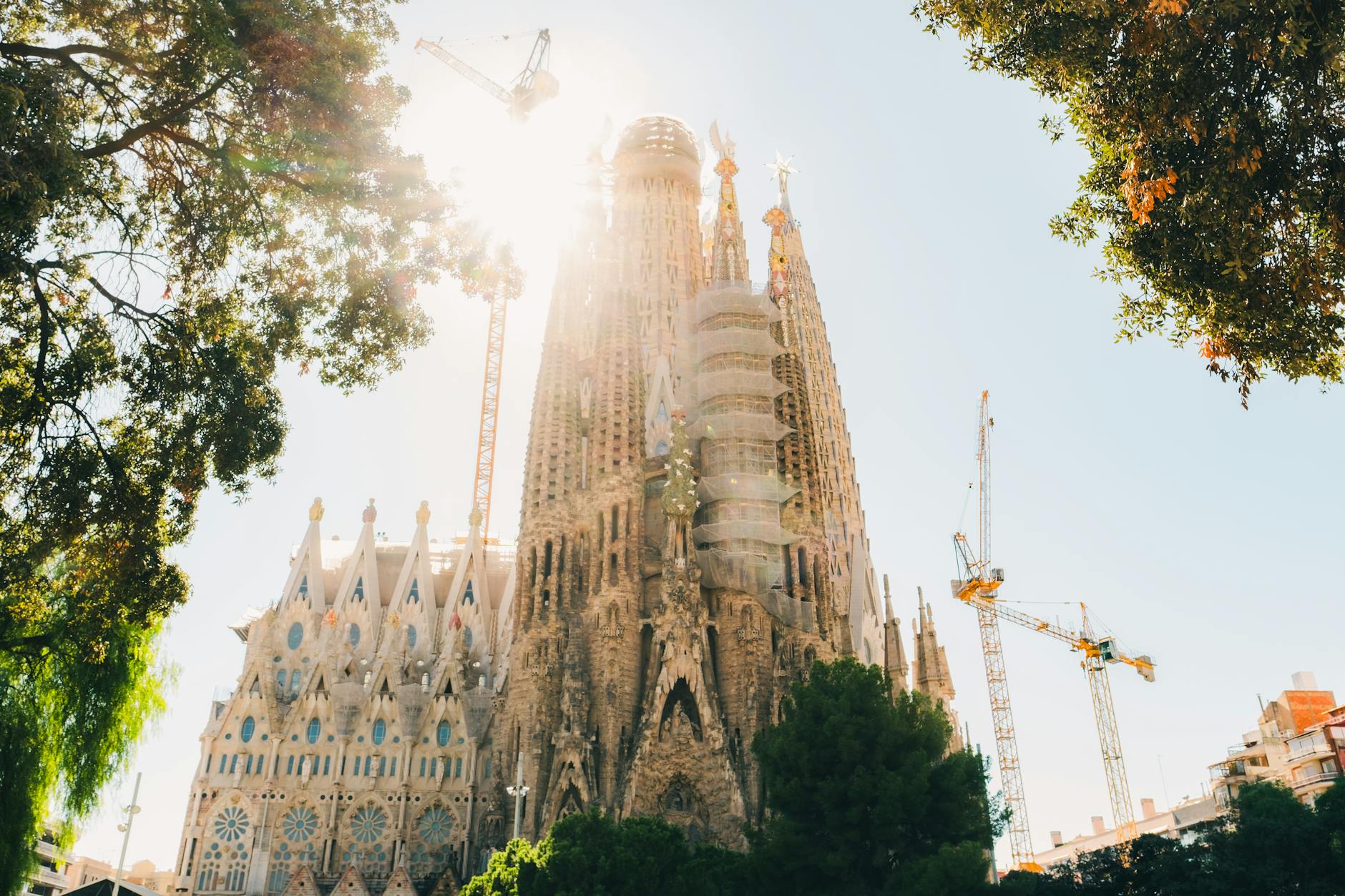 Sagrada Familia basilica facade lit by bright sun in central Barcelona