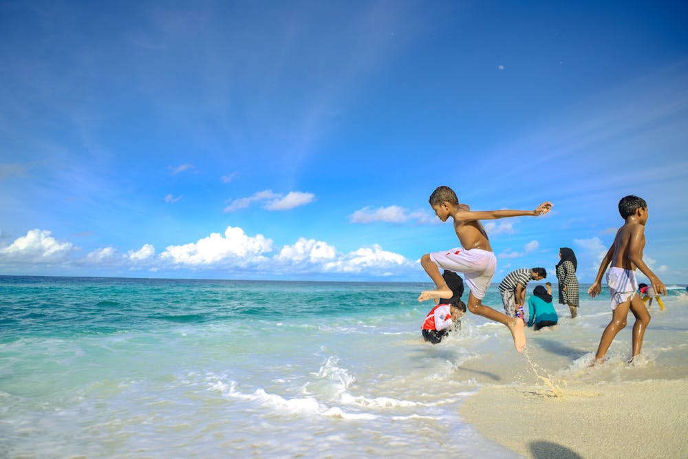 Children playing on beautiful Caribbean beach in Punta Cana