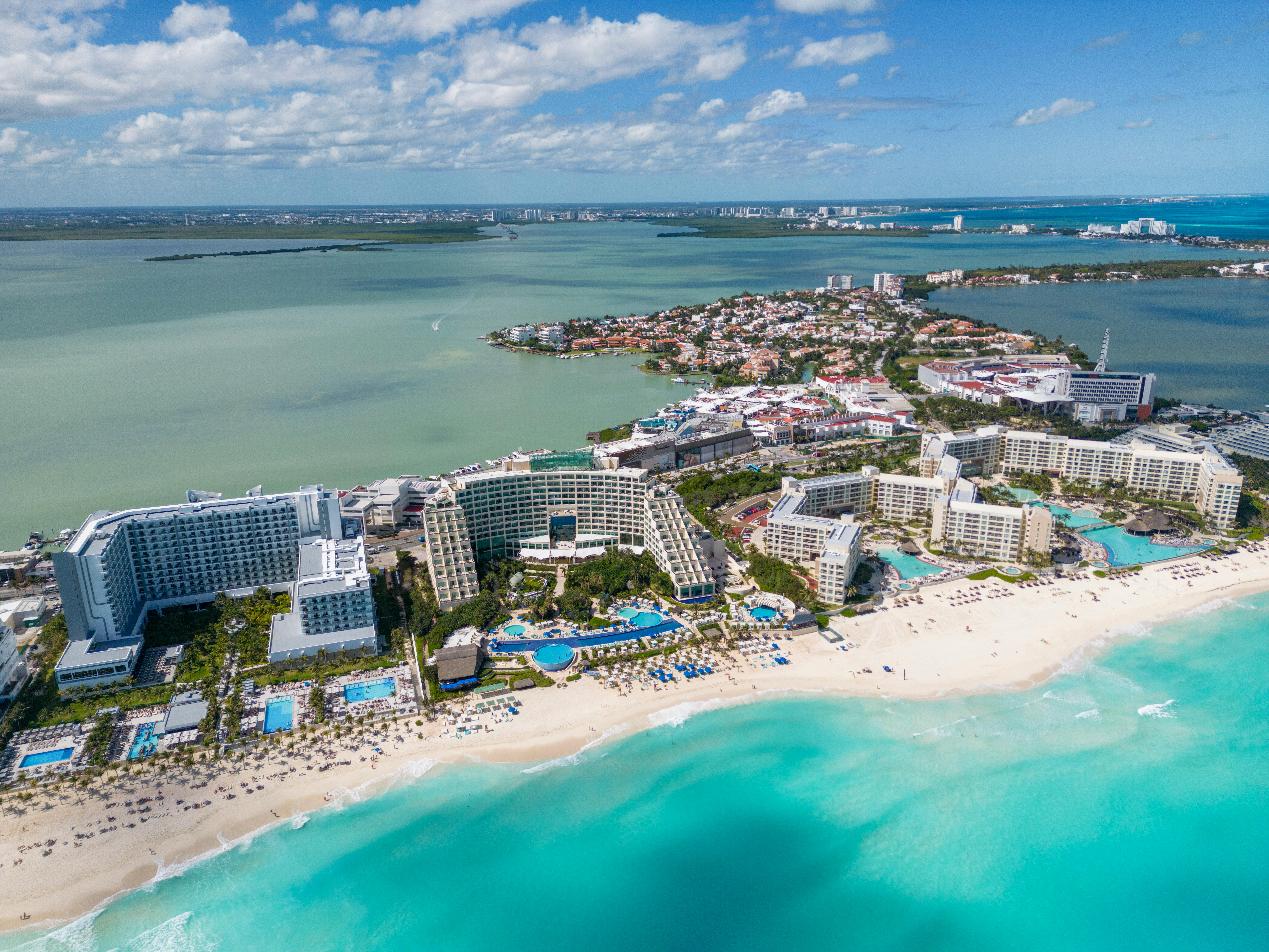 Aerial view of Cancun resorts and turquoise sea representing the Cancun all-inclusive hotel-zone family-resort tier