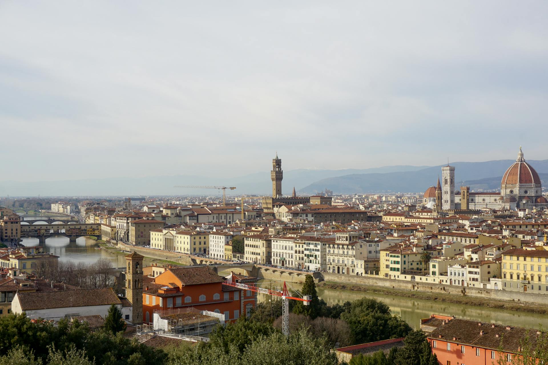 Aerial view of Florence with the Duomo and Ponte Vecchio visible across the Arno River