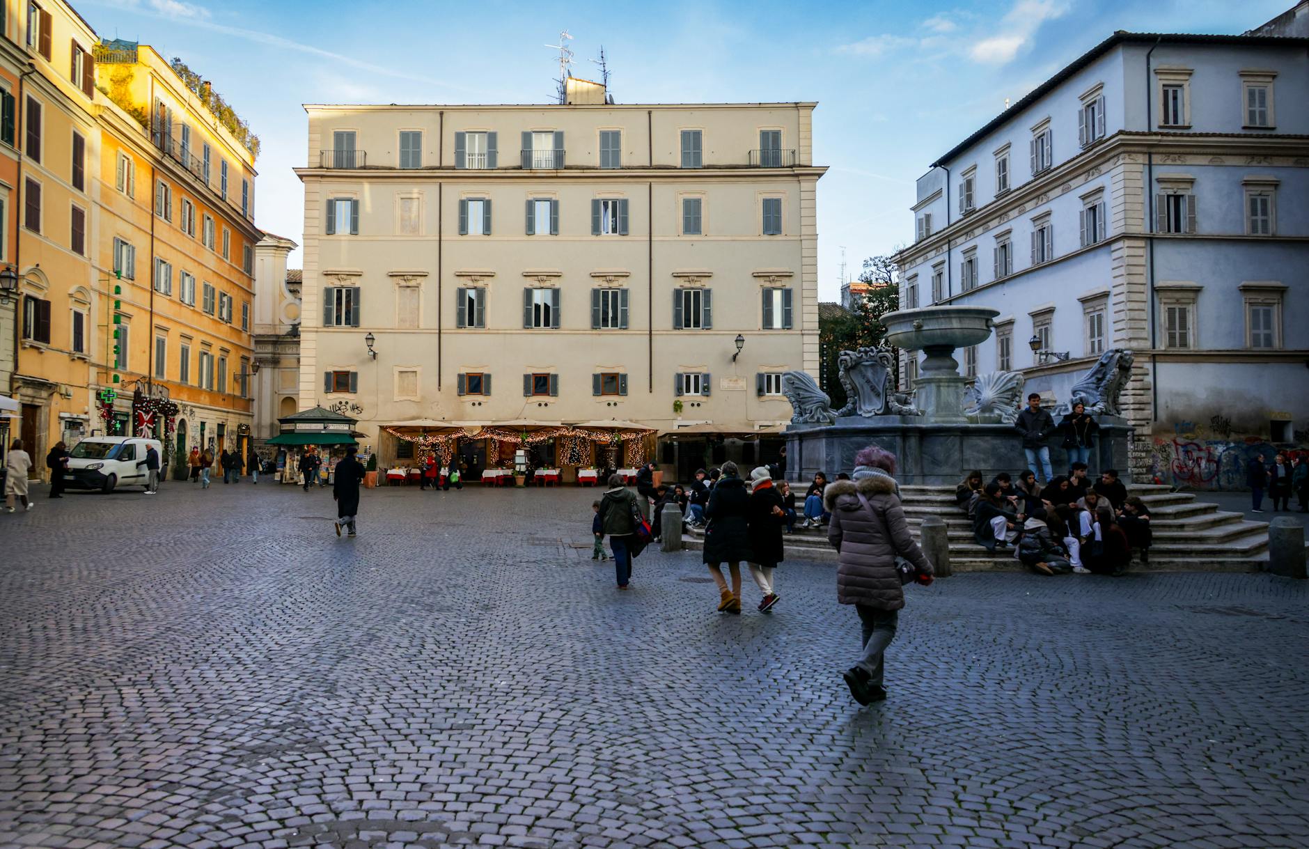 A bustling Roman piazza with cobblestone streets and historic architecture &mdash; the daily-life pace that defines a Rome family vacation between monument days