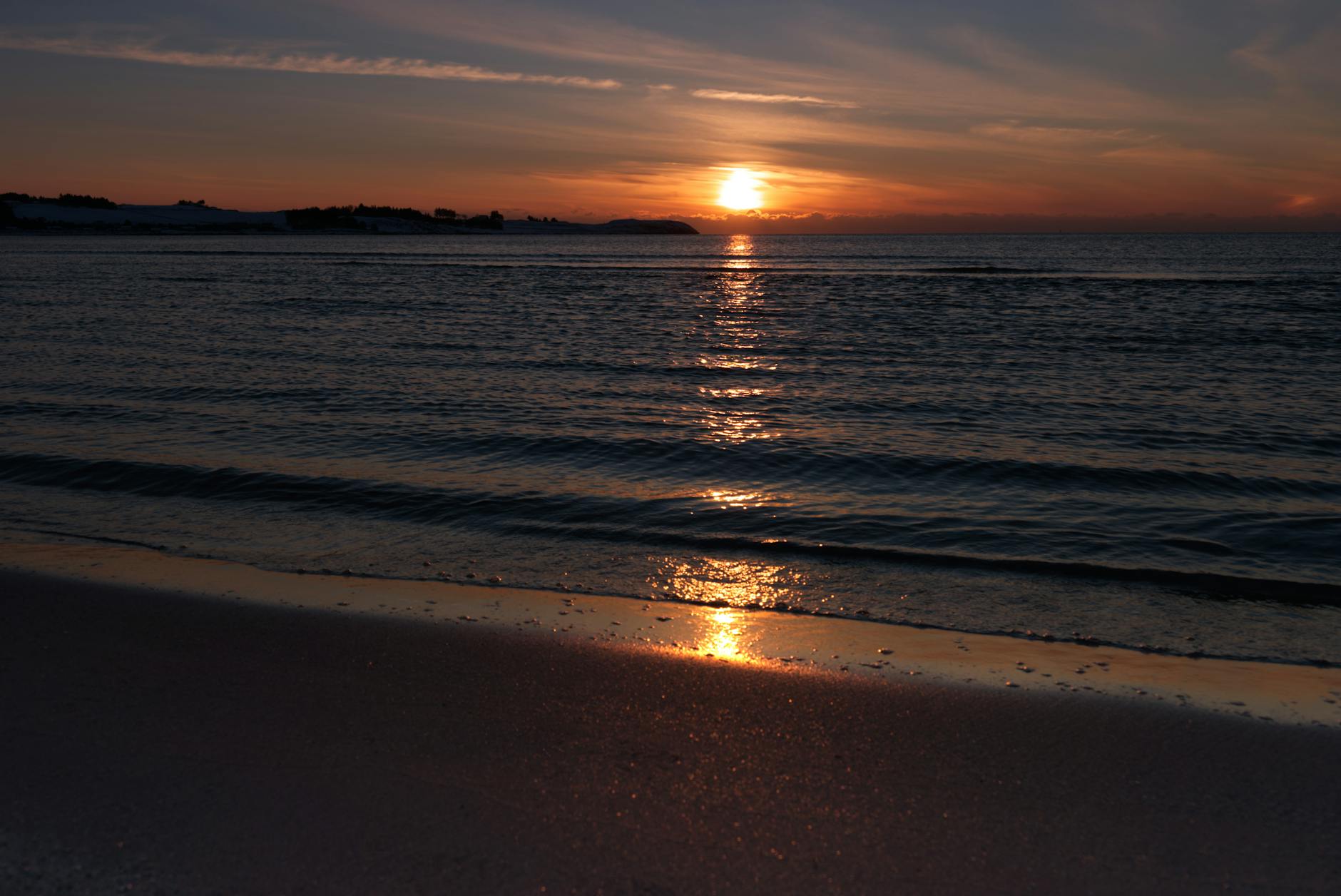Golden sunset over ocean waves on a San Diego beach
