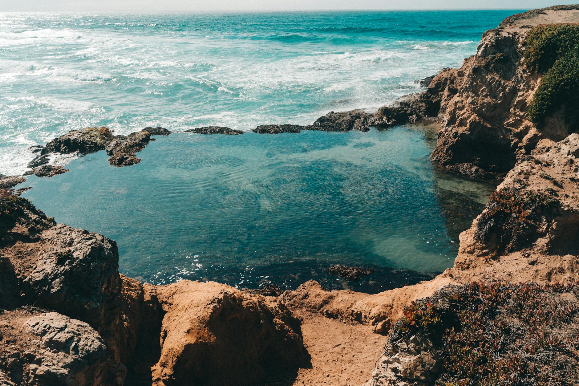Rocky California coastline with natural tide pool formations along the Pacific shore