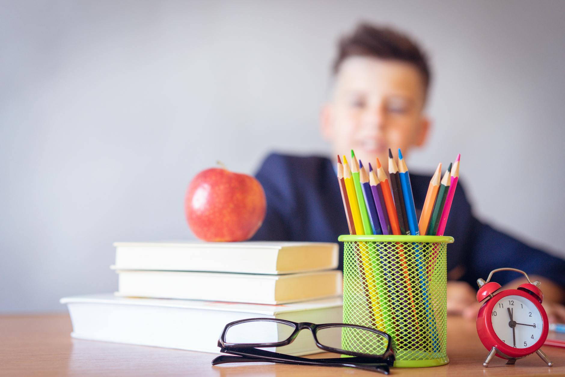 Student at organized desk with calendar and school supplies for strategic planning