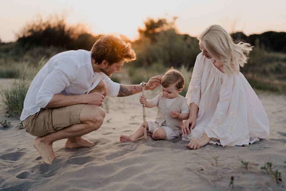 Family with toddler enjoying a beach vacation at sunset