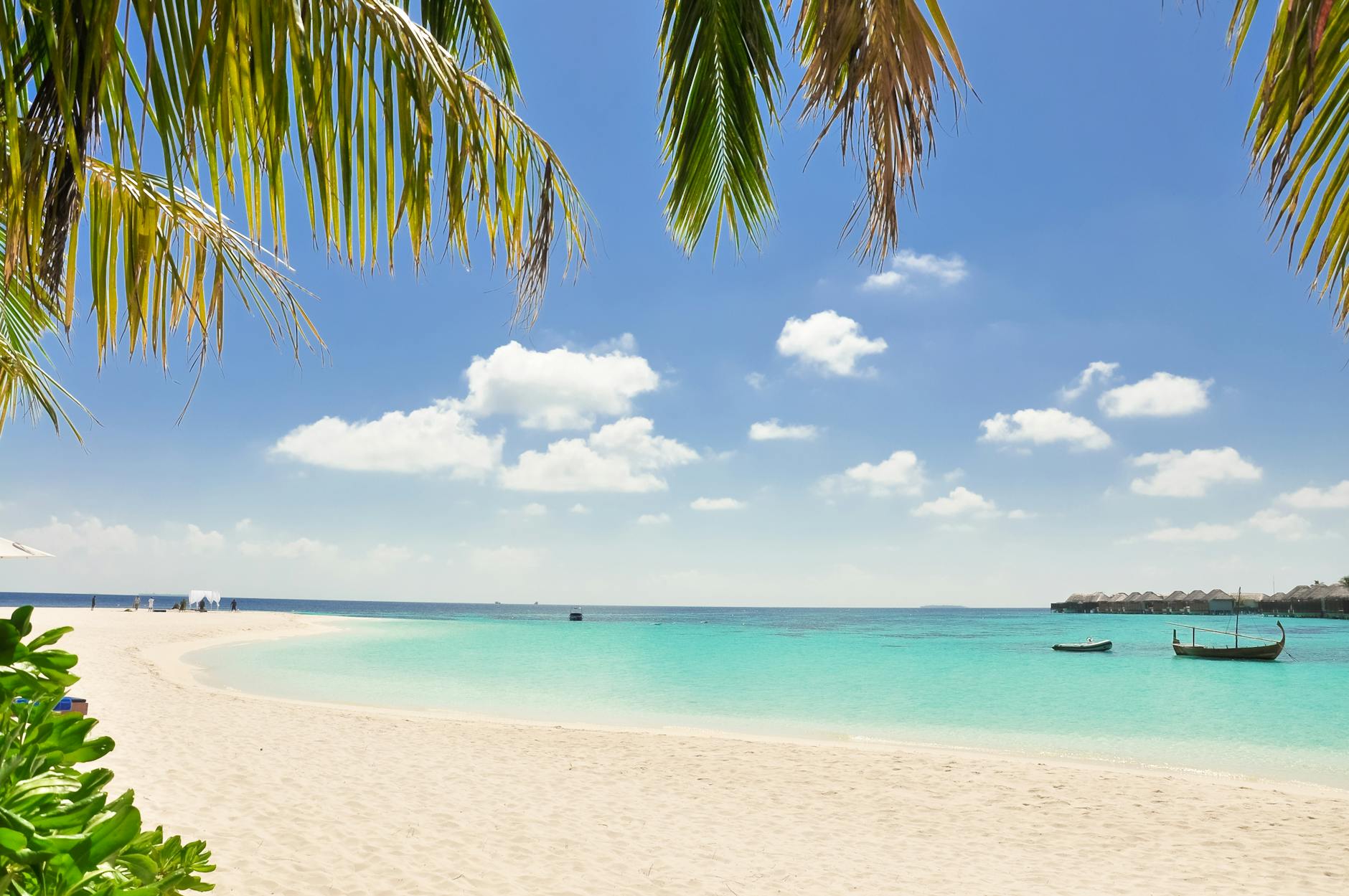 Family enjoying a Mediterranean beach holiday with clear blue water and sandy shoreline