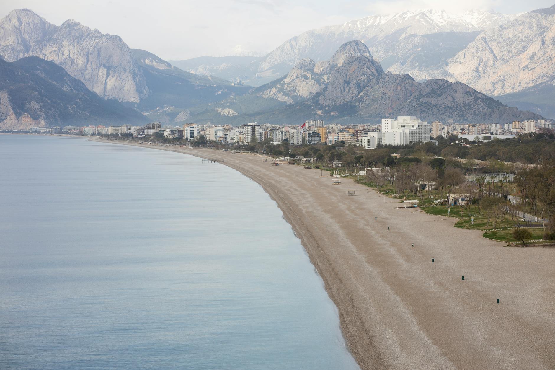 Sandy beach in Antalya, Turkey with the Taurus Mountains rising in the distance