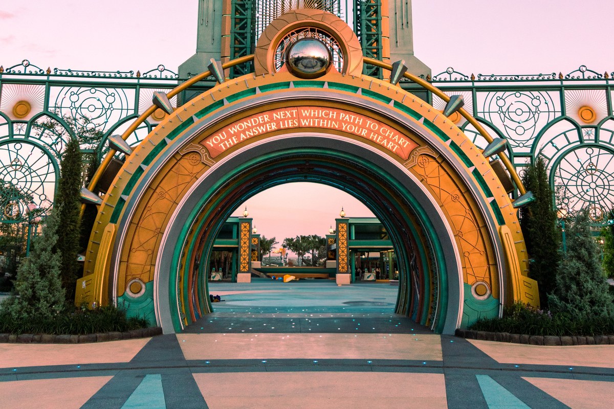 The Chronos entrance arch at Epic Universe at dusk, the gateway every family walks through before Celestial Park