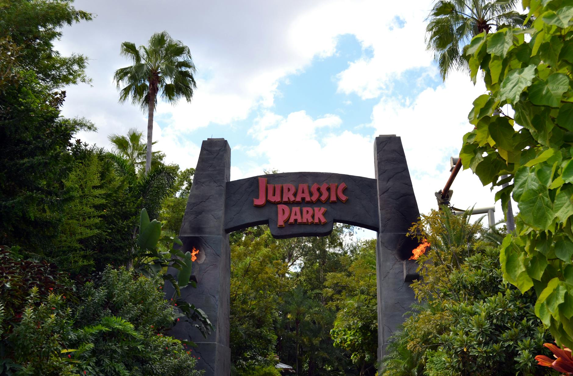 Jurassic Park themed entrance with lush tropical landscaping at Universal Orlando