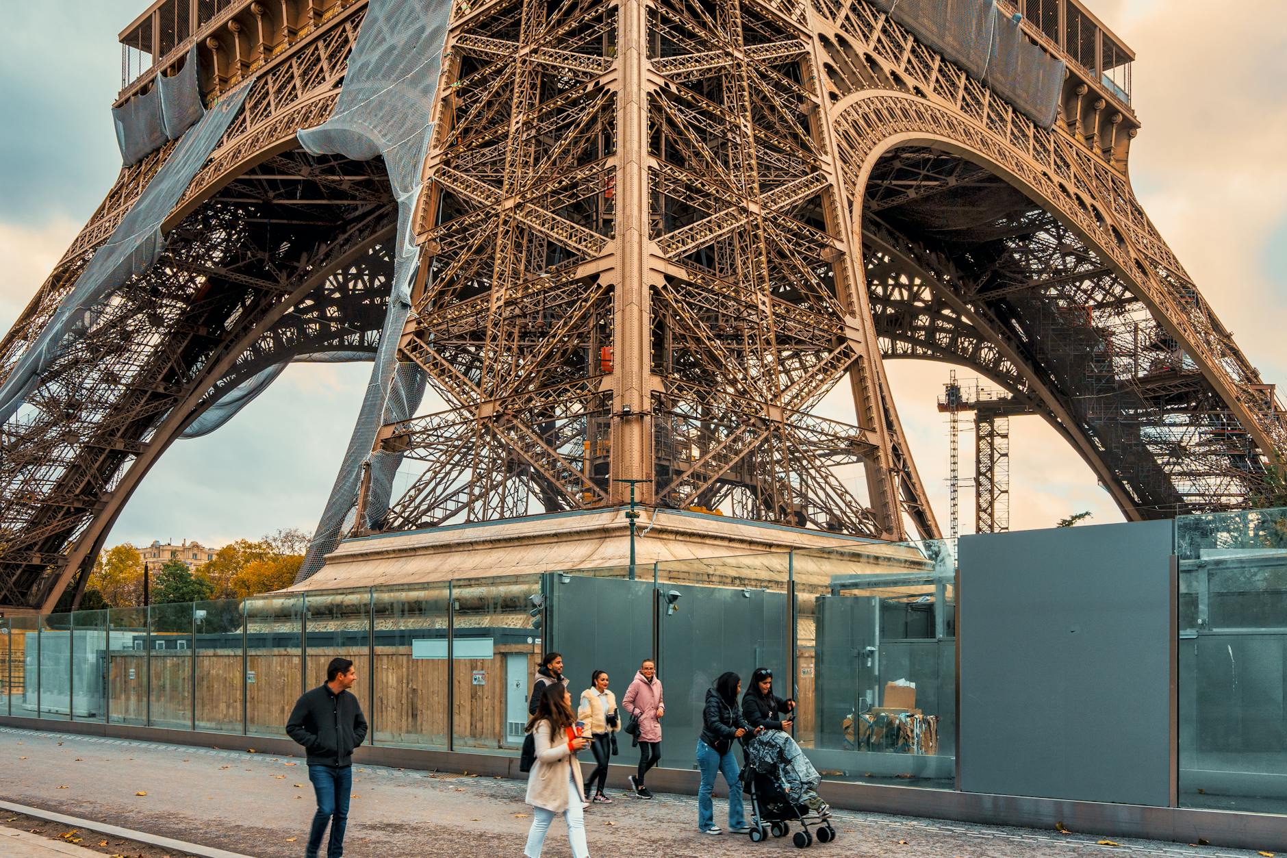 Family walking beneath the Eiffel Tower in Paris, typical of a US family Europe trip 2026