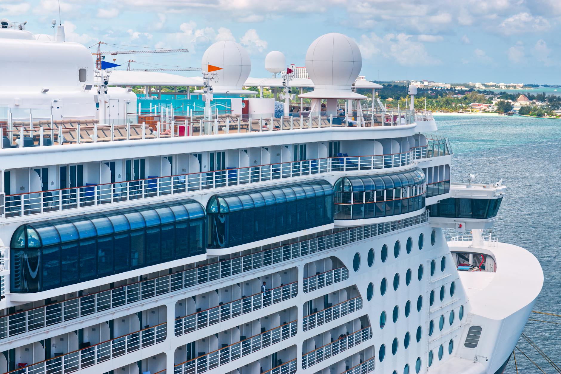 Luxury cruise ship docked at a tropical Caribbean port representing the cruise vacation type and its onboard hidden cost stack