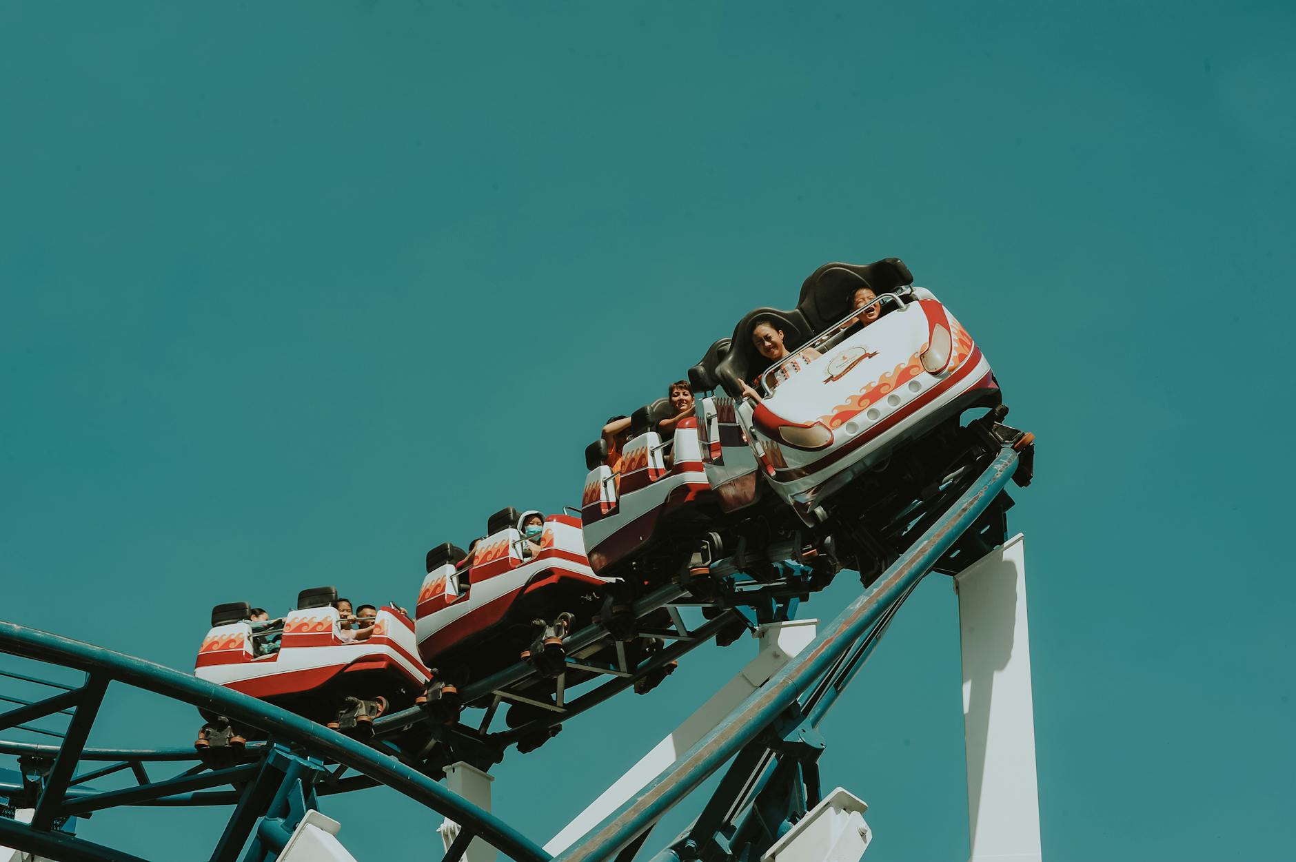 Family enjoying a roller coaster ride at a theme park representing the highest hidden cost risk vacation type