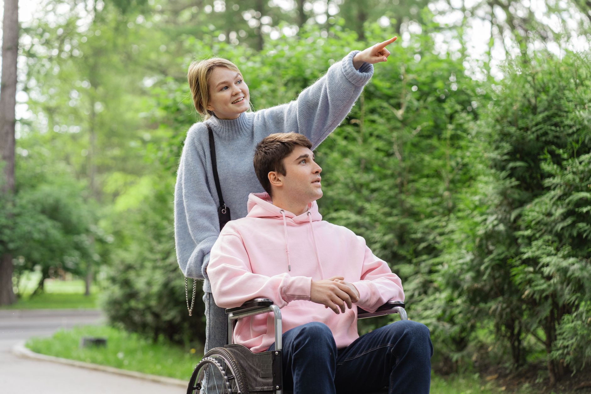 A parent and a wheelchair-using traveler at a scenic overlook reached by a step-free accessible route, mapped before the trip