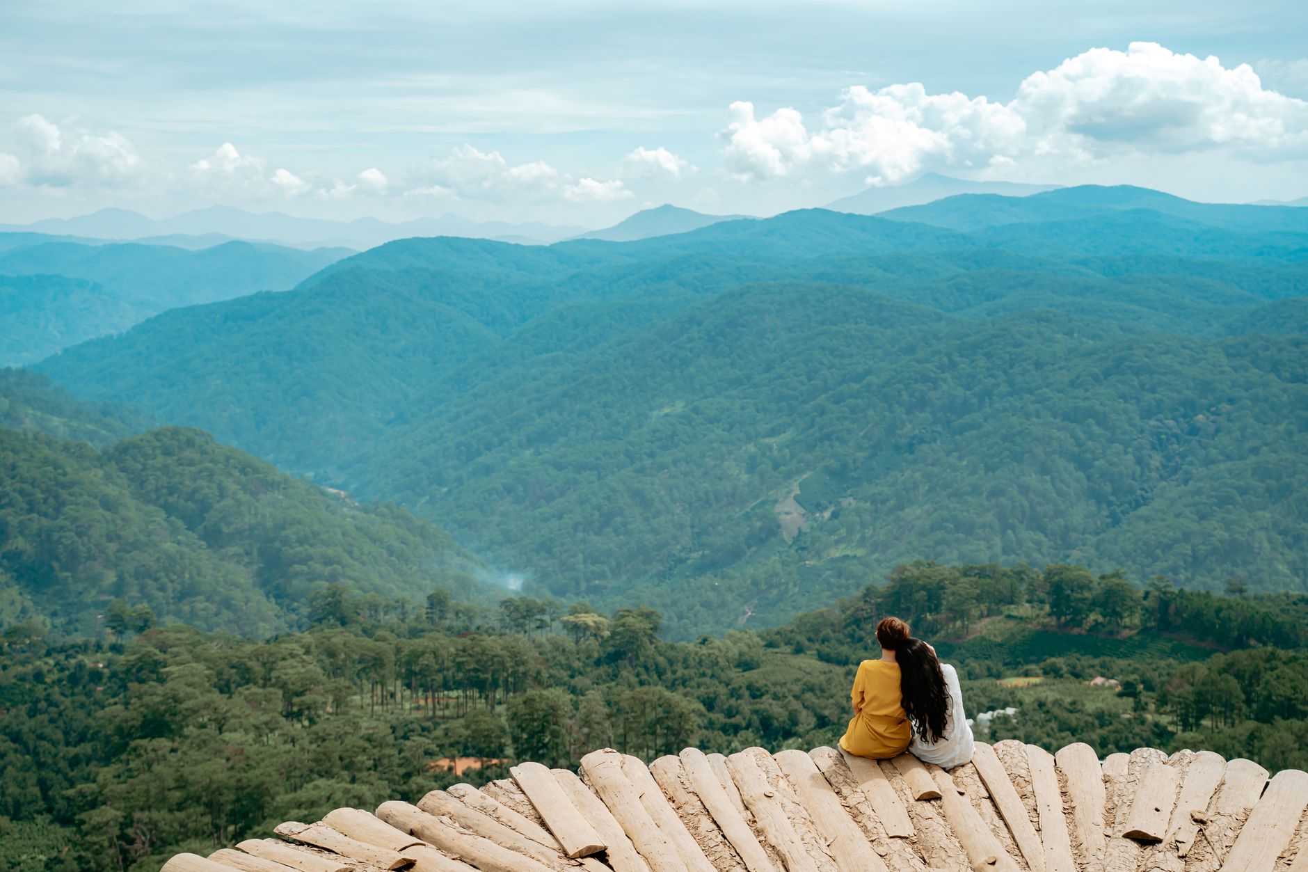 Wheelchair user on a paved accessible national park boardwalk overlooking scenery, a step-free national park family vacation option