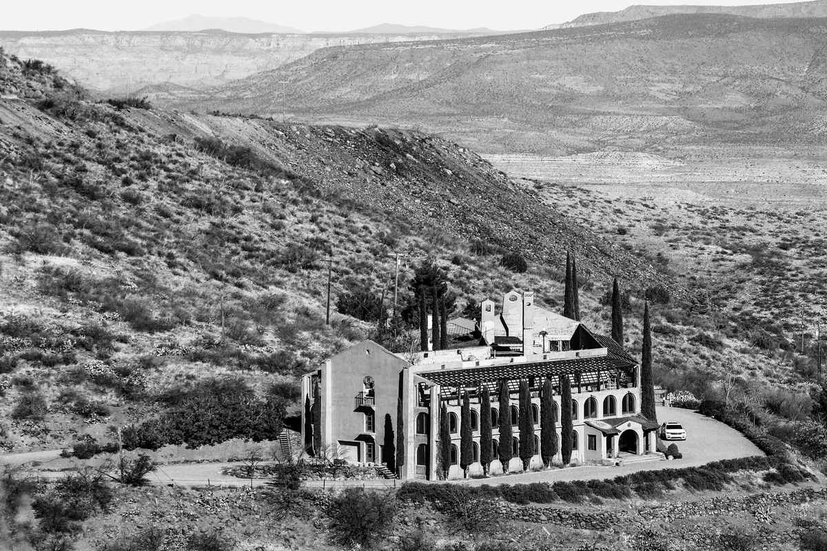 Modern desert resort hotel with mountain backdrop and swimming pool, showcasing family-friendly lodging amenities near Zion