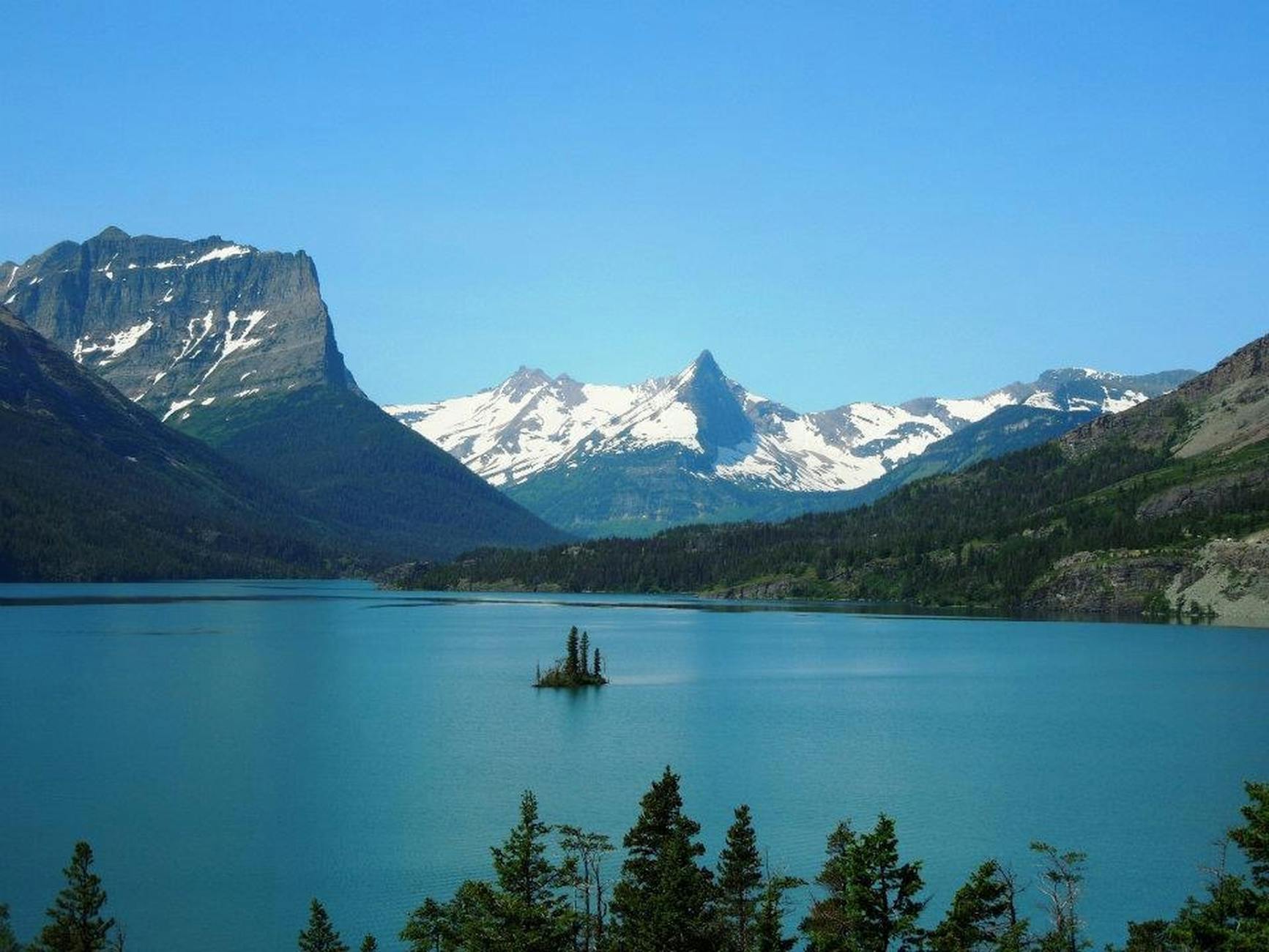 Snow-capped mountains and clear lake at Glacier National Park Montana