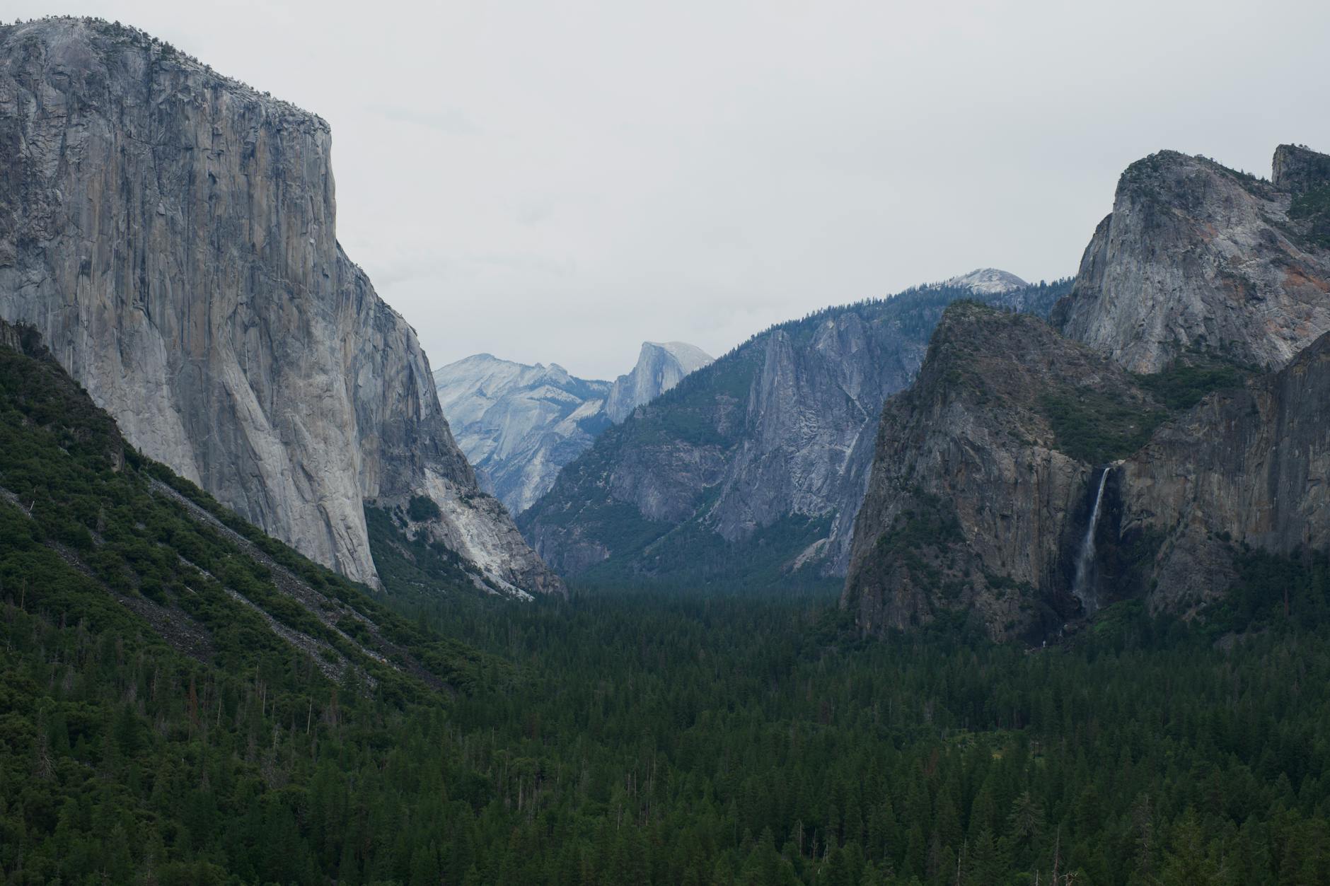 Yosemite Valley featuring El Capitan granite cliff and cascading waterfall