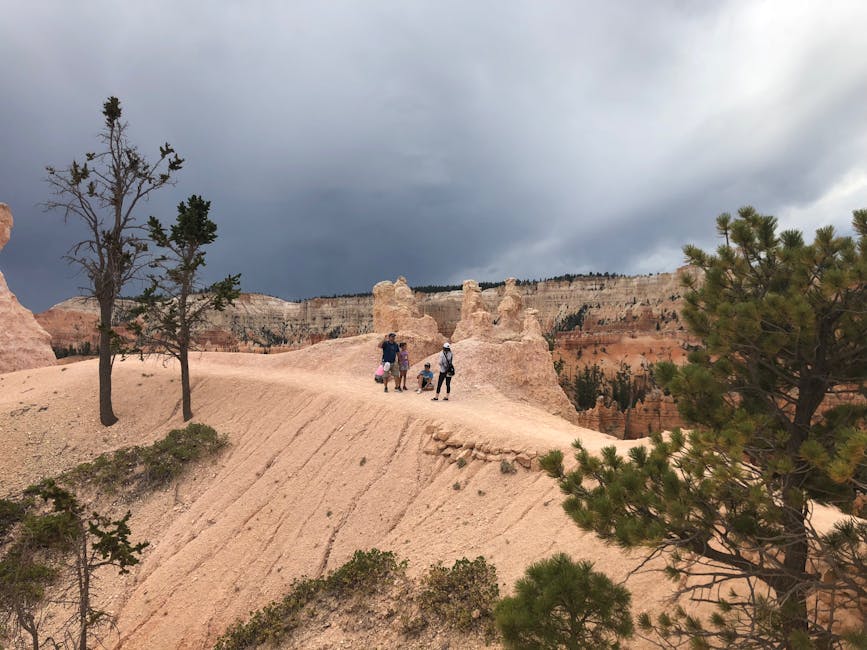 Visitors hiking a scenic trail at Bryce Canyon surrounded by iconic hoodoo rock formations